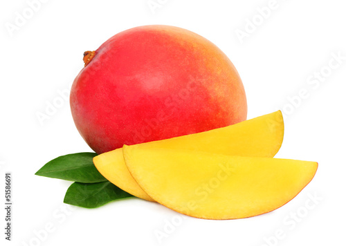 One whole mango and slices with green leaves (isolated)