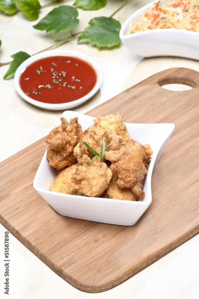Fried chicken nuggets in white bowl Fried chicken nuggets in white bowl