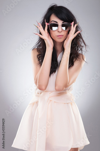 fashion woman takes off glasses