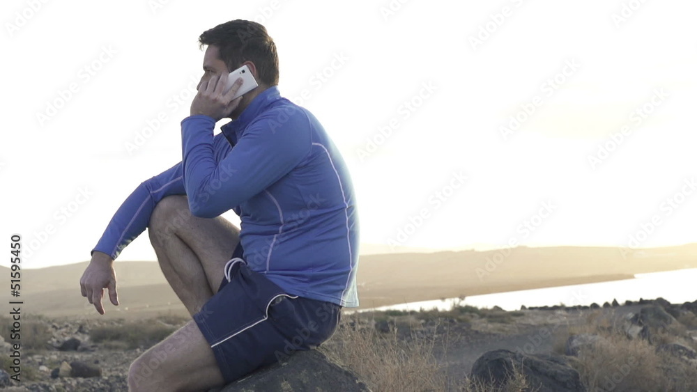 Young jogger talking on the cellphone, super slow motion Young jogger talking on the cellphone, super slow motion