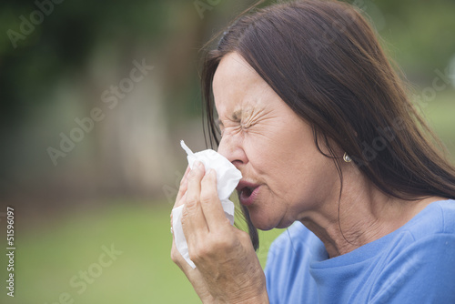 Sick mature woman suffering flu or hayfever photo
