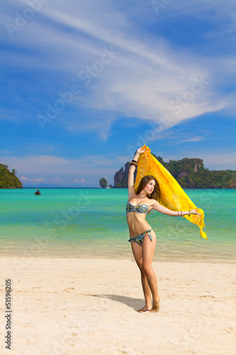 Young woman with sarong on the beach