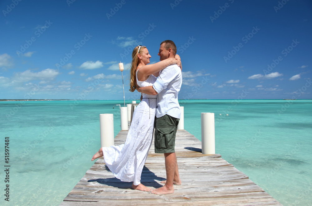 A couple on the wooden jetty. Exuma, Bahamas