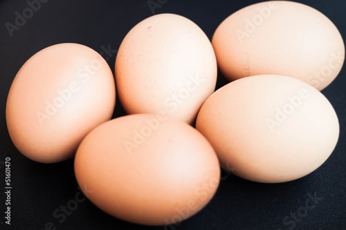 Organic chicken eggs in a black tray