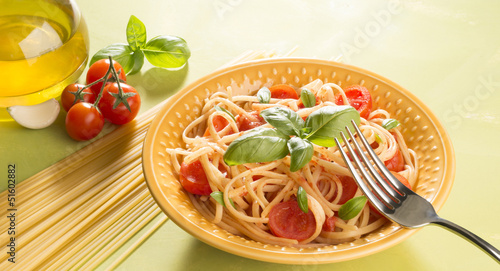 Dish with spaghetti tomatoes and basil