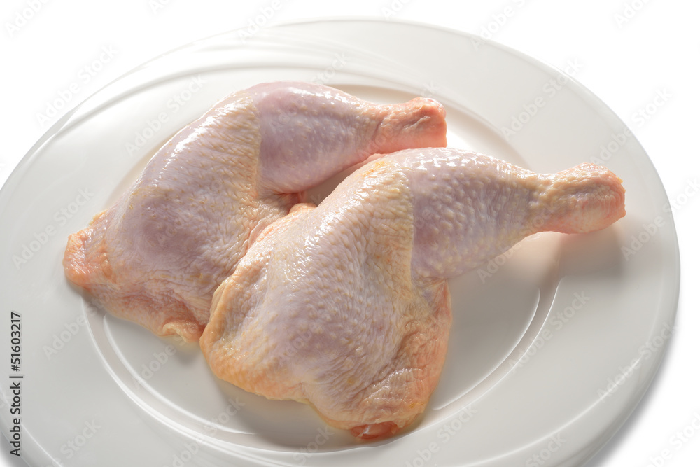fresh chicken thighs on white plate
