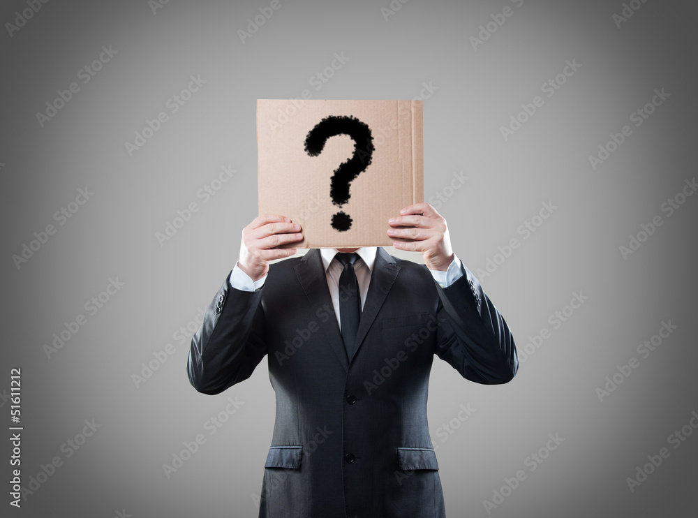 Businessman holding a card with question Businessman holding a card with question