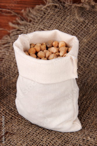 Beans in sack on wooden background