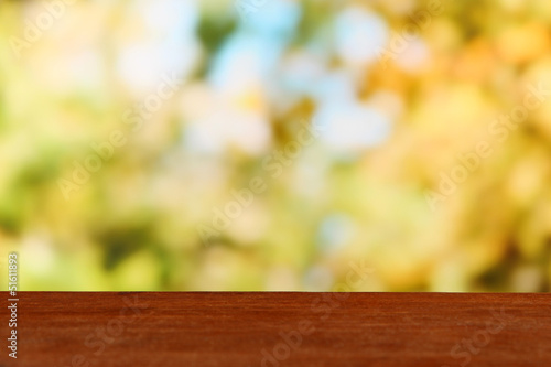 Wooden table on bright background