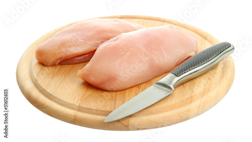 raw chicken meat on cutting board, isolated on white