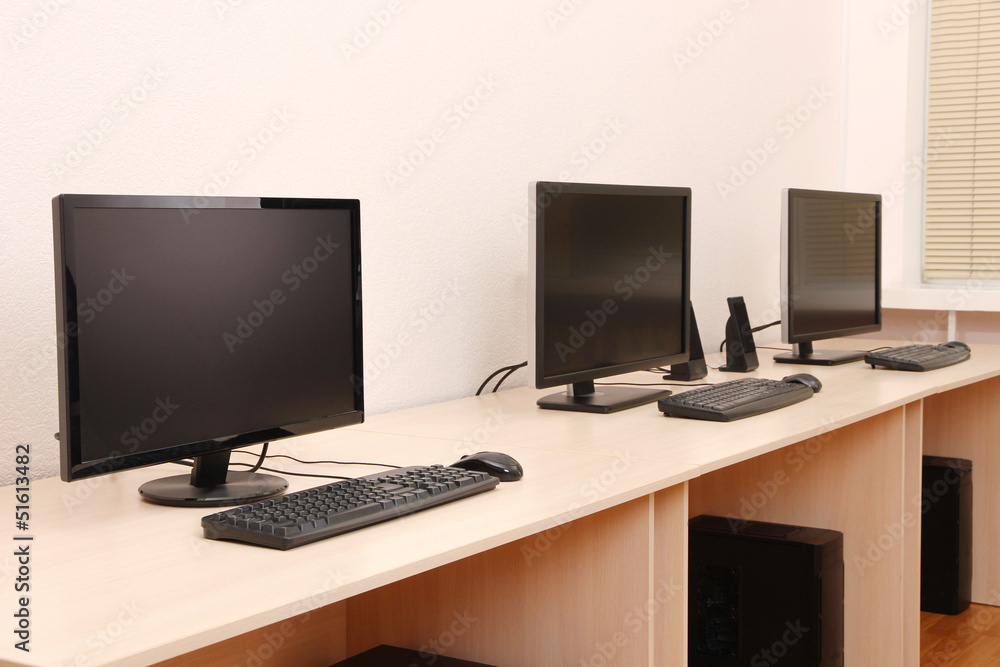 Computers on tables in room Computers on tables in room