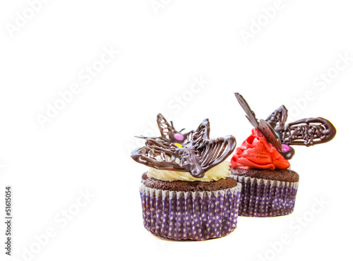 Chocolate butterfly decorated cupcakes on white background