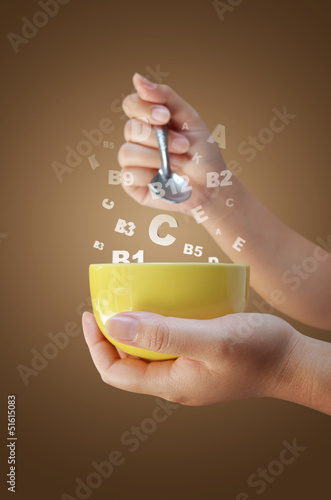 hand holding cup and spoon