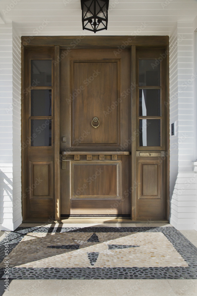 Wooden front door of an upscale home Wooden front door of an upscale home