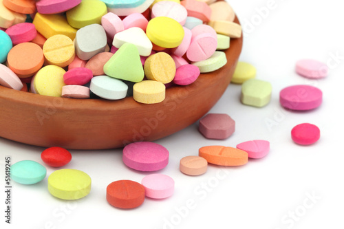 Colorful tablets spilled from a clay pottery