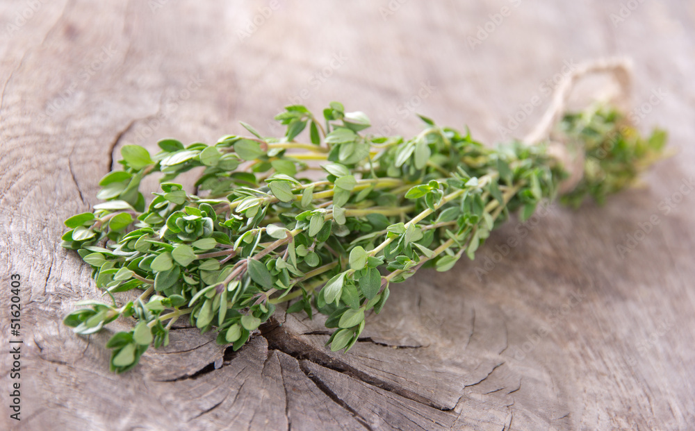 Fresh thyme on wooden table