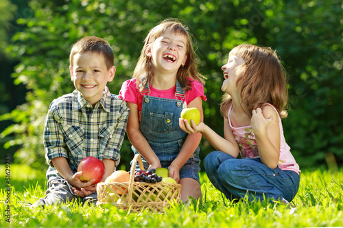 Three happy smiling child playing in park