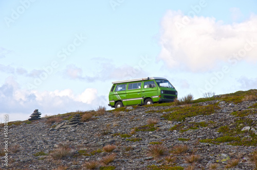 Fototapeta Naklejka Na Ścianę i Meble -  Minivan climbing a hill
