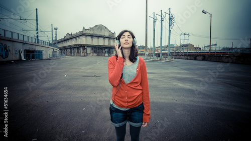 Beautiful stylish woman listening to music