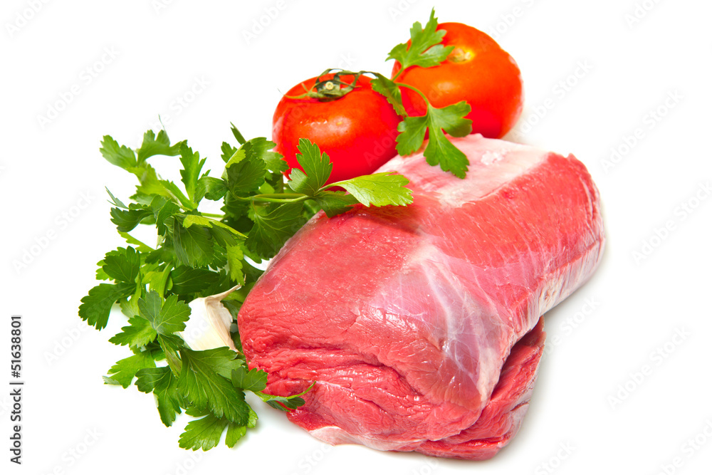 Piece of raw beef with parsley and tomatoes - isolated on white Piece of raw beef with parsley and tomatoes - isolated on white