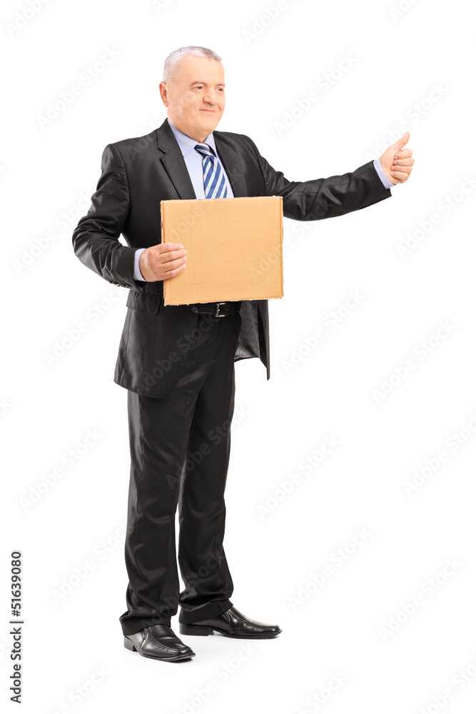 Full length portrait of a mature man in suit hitchhiking Full length portrait of a mature man in suit hitchhiking