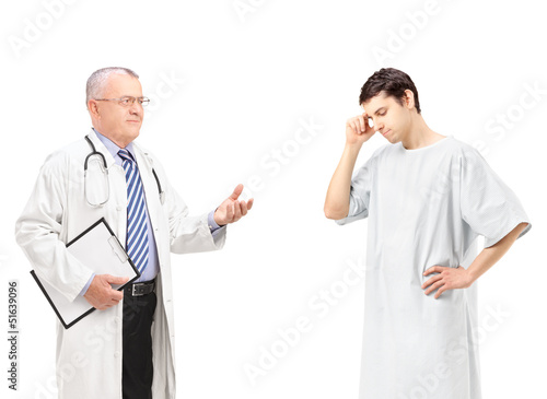 Mature doctor talking to a worried male patient
