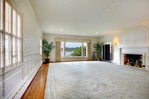 Large empty living room with fireplace
