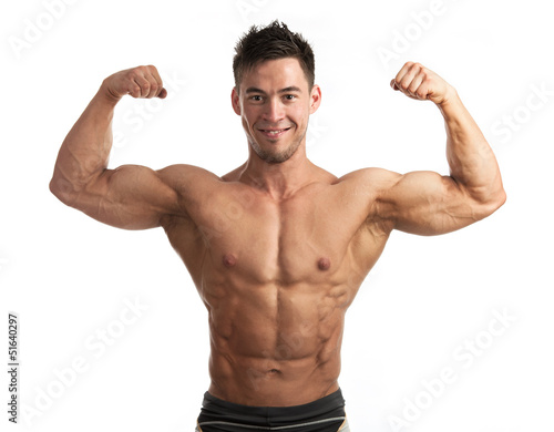 Waist-up portrait of muscular man flexing his biceps