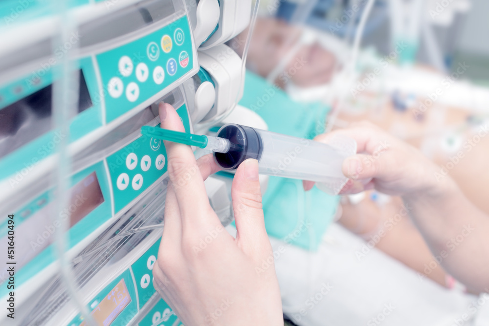 Syringe in the hand of a nurse on the background of the patient Syringe in the hand of a nurse on the background of the patient