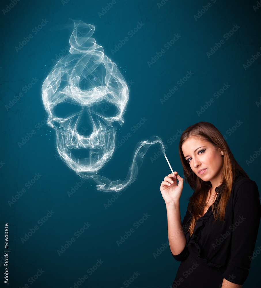 Fototapeta premium Young woman smoking dangerous cigarette with toxic skull smoke