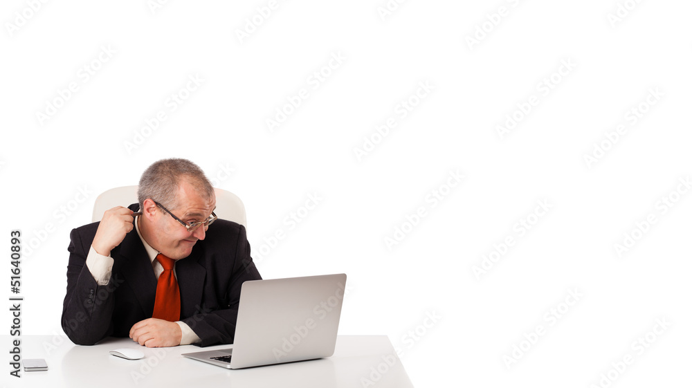 buisnessman sitting at desk and looking laptop with copy space