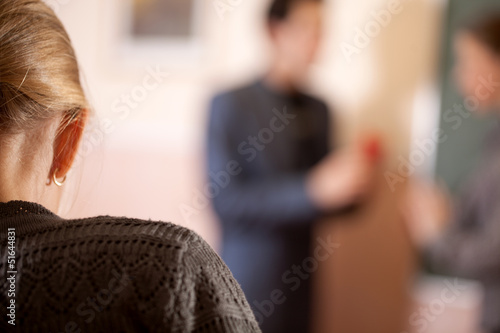 Schoolgirl overhearing two teachers conversation