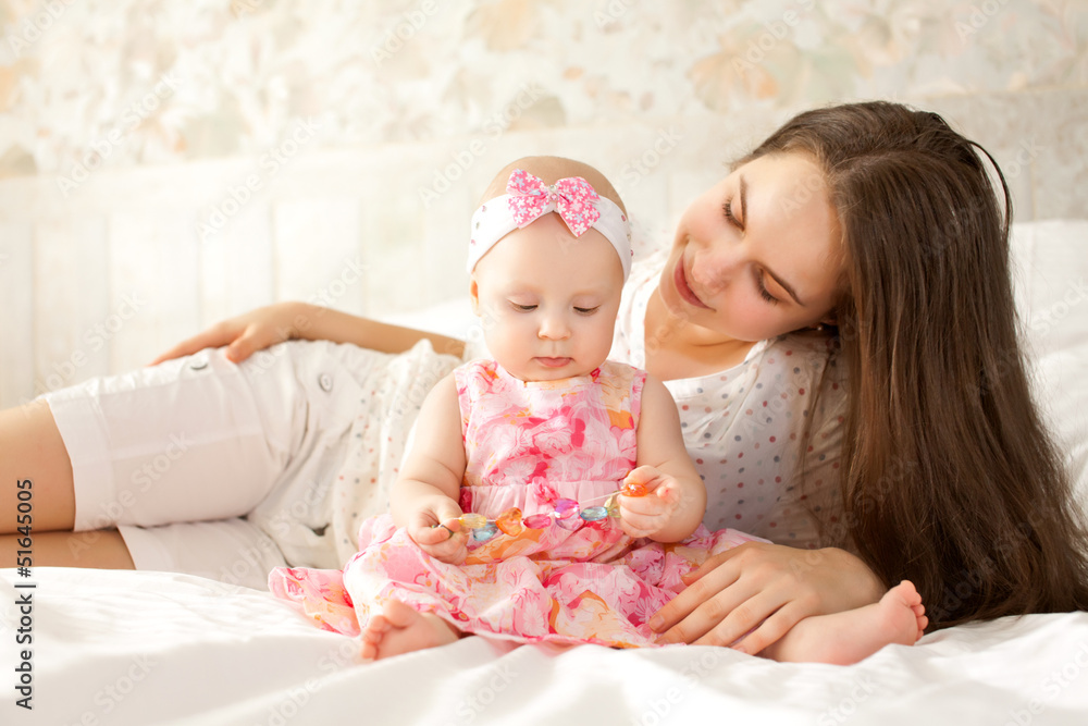 happy-looking baby and mother playing together happy-looking baby and mother playing together