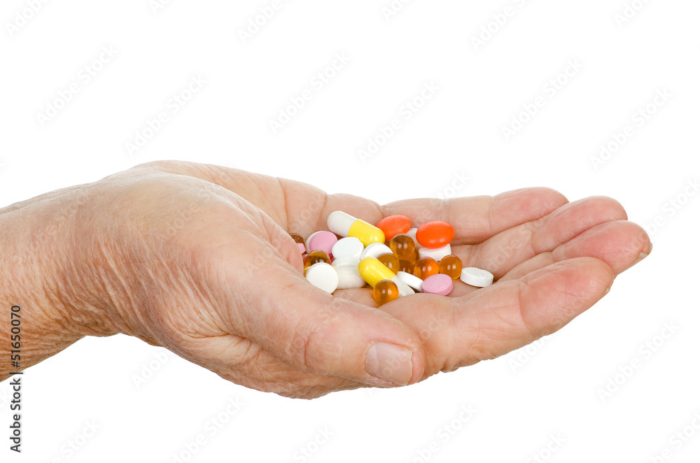 hand of the old woman with pills. isolated on white hand of the old woman with pills. isolated on white