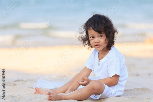 Asian boy play on beach