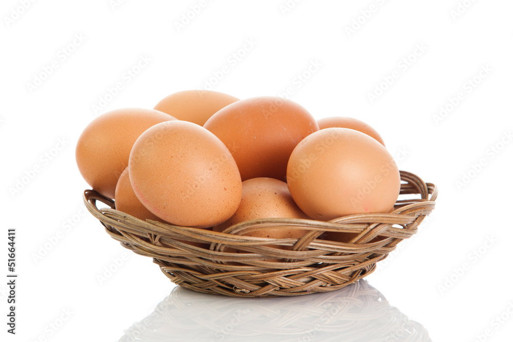 Brown eggs in the basket on white. Brown eggs in the basket on white.