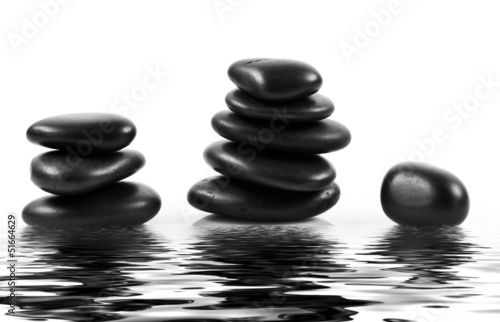 Black massage stones stacked  isolated.