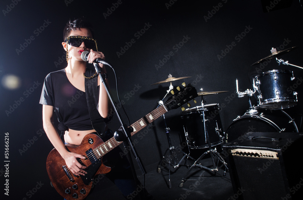 Woman guitar player during concert