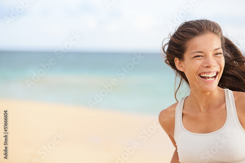Beach fun - running woman closeup with copy space