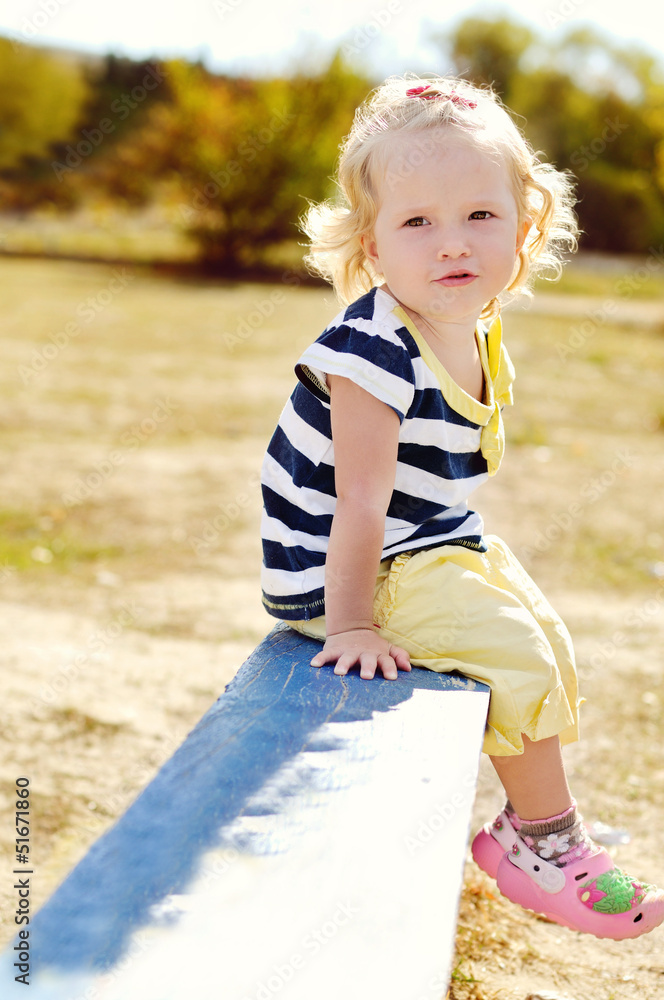Fototapeta premium toddler sitting on the bench