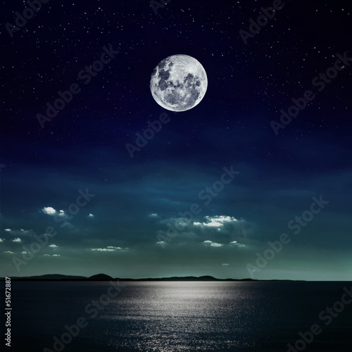 Full moon reflected on the beach
