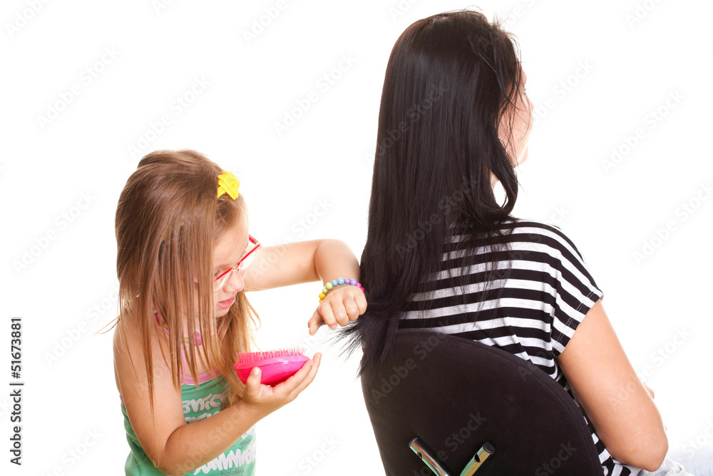 litle baby girl brushing her mothers hair litle baby girl brushing her mothers hair