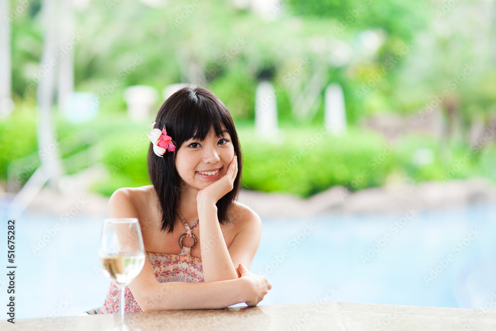 a young asian woman relaxing in the resort hotel