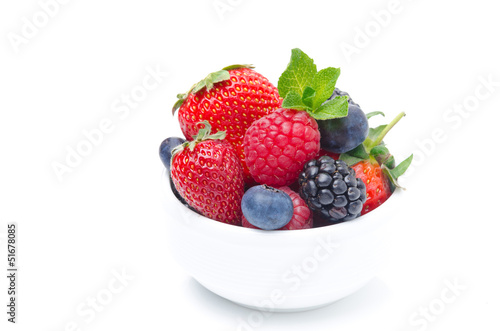 Assorted berries in a white bowl isolated on white