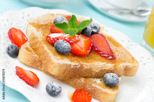 crispy toast with honey, fresh berries, cup of coffee and juice