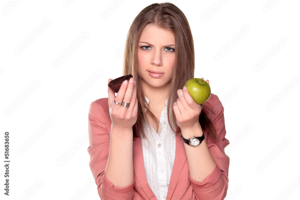 teenager girl holding apple and chocolate cake in her hands teenager girl holding apple and chocolate cake in her hands