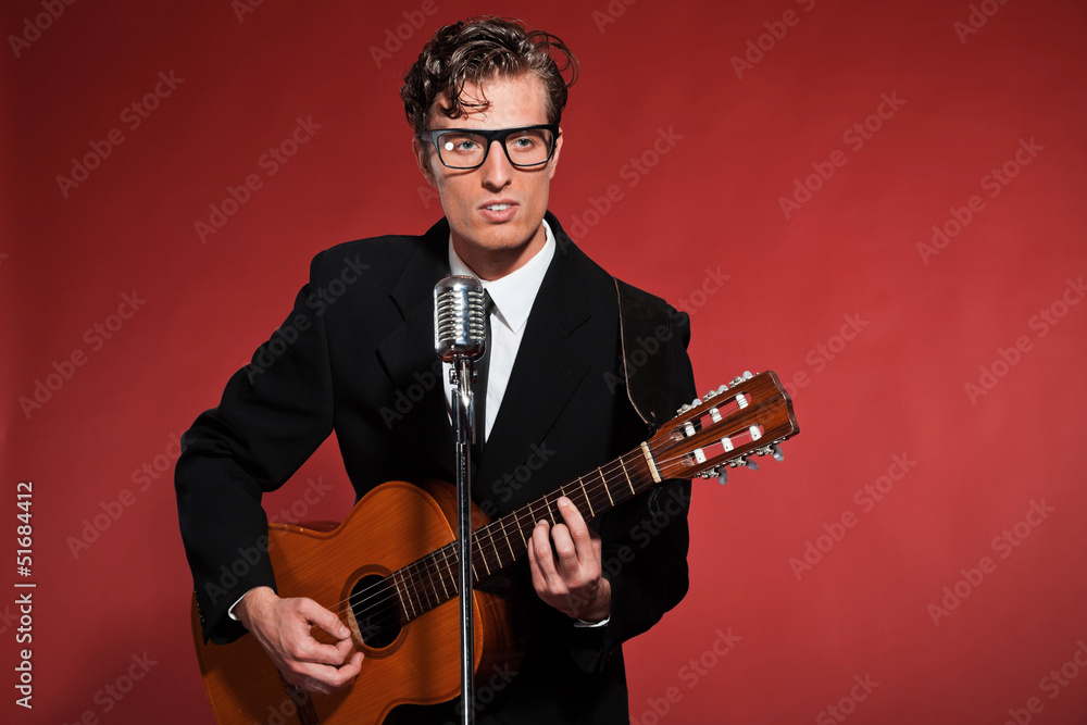 Obraz premium Retro fifties musician with glasses playing acoustic guitar. Stu