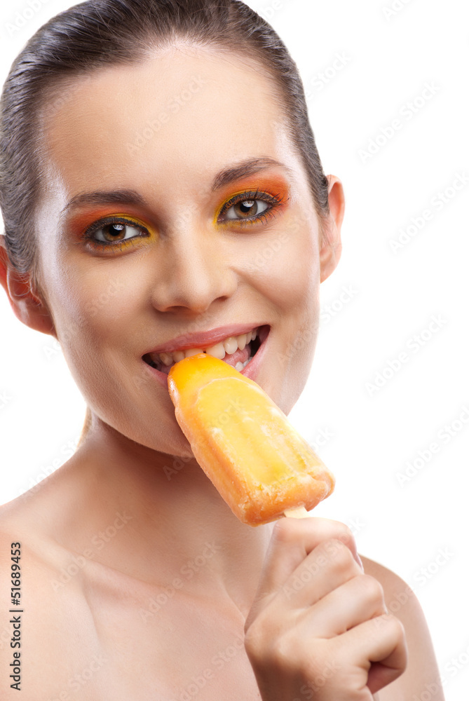 Woman eating orange ice-cream and having fun Woman eating orange ice-cream and having fun