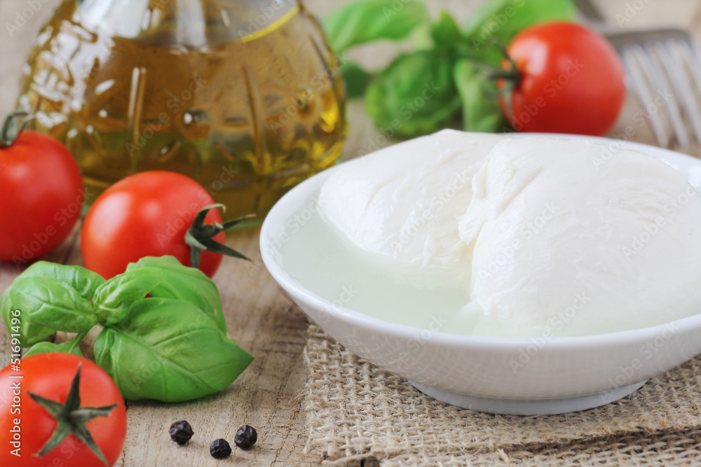 Fresh balls of mozzarella cheese with tomatoes and basil Fresh balls of mozzarella cheese with tomatoes and basil