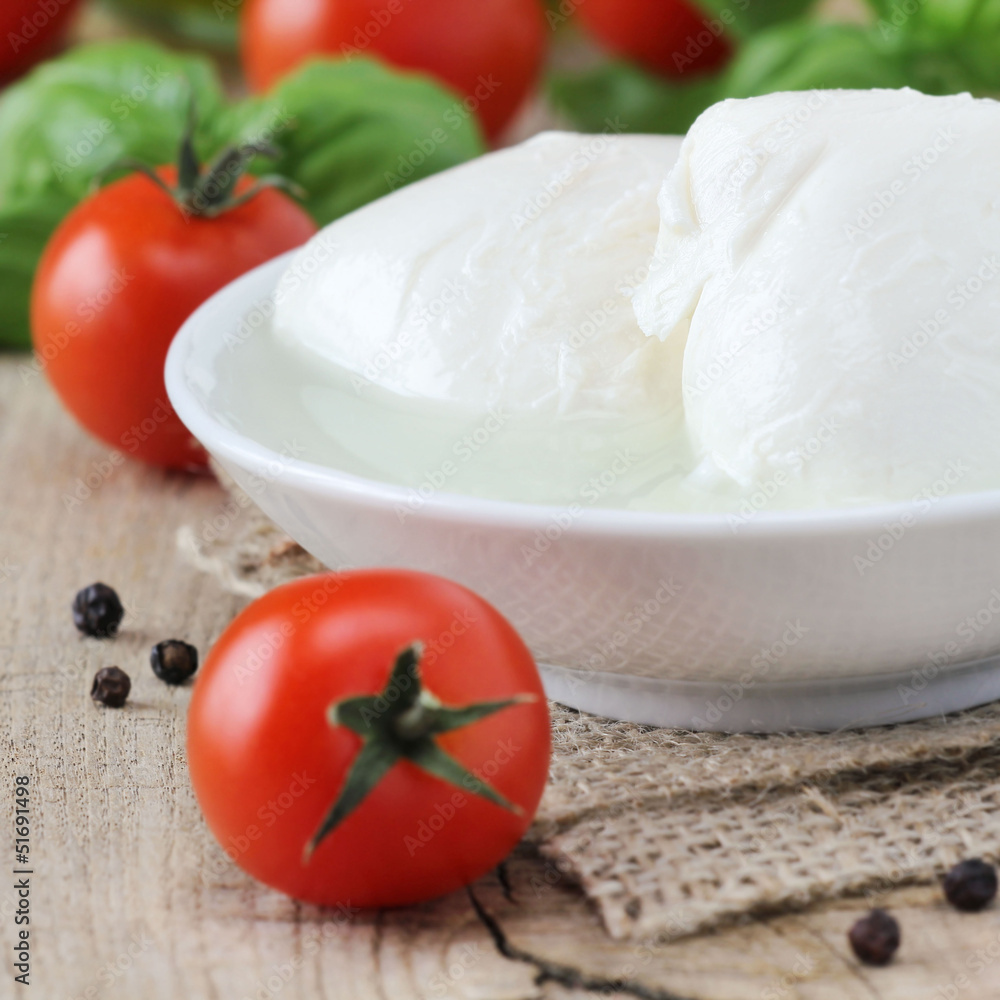 Fresh balls of mozzarella cheese with tomatoes and basil Fresh balls of mozzarella cheese with tomatoes and basil